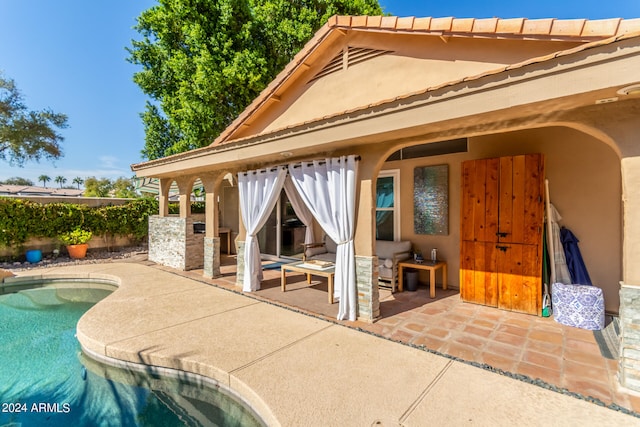 back of house featuring a patio and a fenced in pool