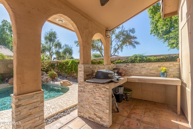 view of patio with a fenced in pool, area for grilling, and a grill