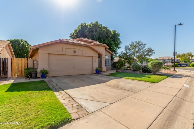 view of front of property with a front yard and a garage