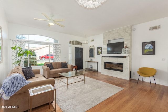 living room with ceiling fan, hardwood / wood-style flooring, and a premium fireplace