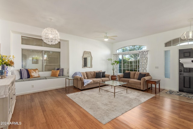 living room featuring hardwood / wood-style flooring and ceiling fan with notable chandelier