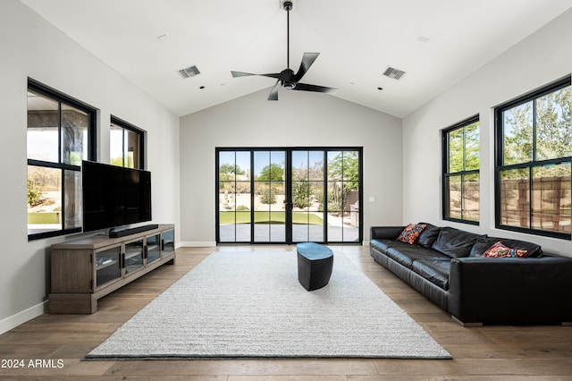 living room featuring a wealth of natural light, vaulted ceiling, hardwood / wood-style floors, and ceiling fan