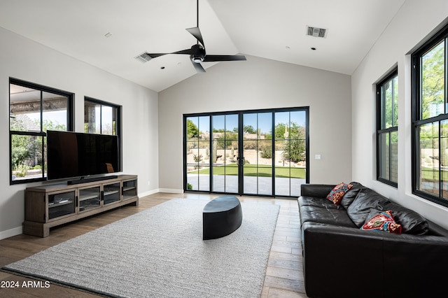 living room with lofted ceiling, ceiling fan, and wood-type flooring