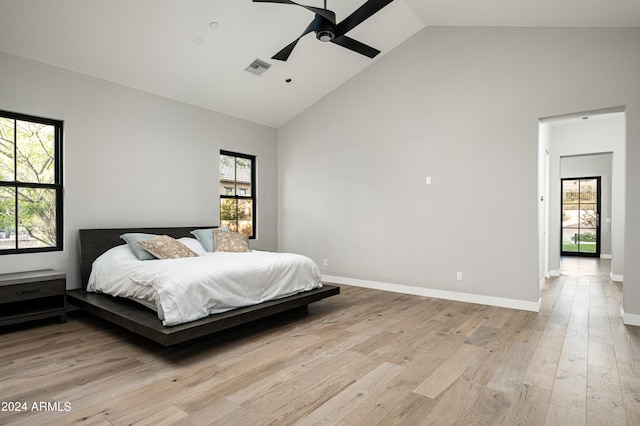 bedroom with light hardwood / wood-style flooring, ceiling fan, and multiple windows