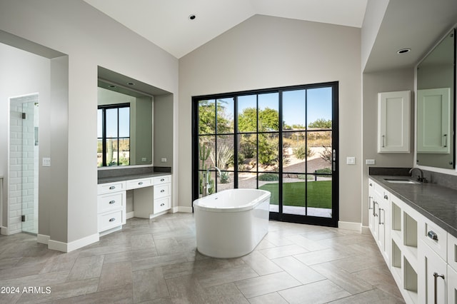 bathroom with vanity, vaulted ceiling, tile patterned floors, and shower with separate bathtub