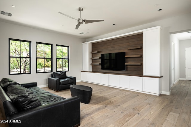 living room with ceiling fan and light hardwood / wood-style floors