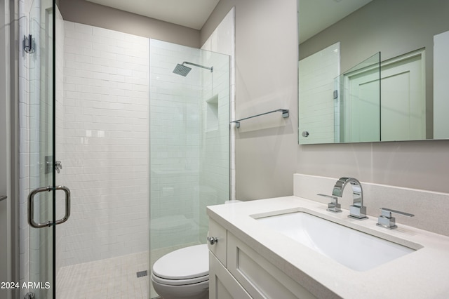 bathroom featuring vanity, toilet, and walk in shower