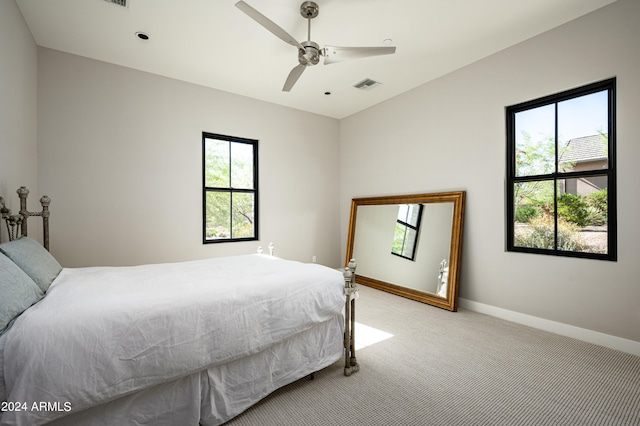 bedroom featuring light carpet and ceiling fan