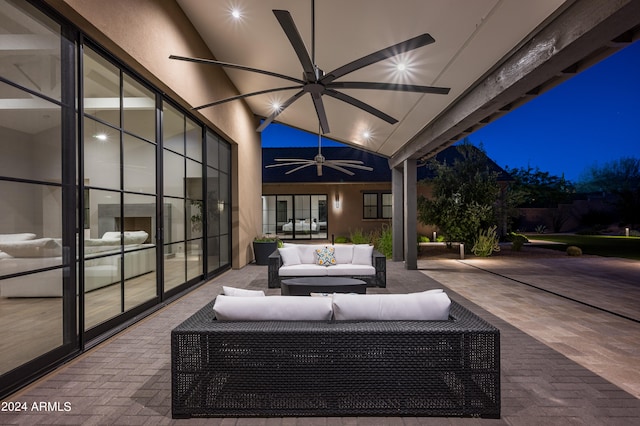 patio at twilight with french doors, ceiling fan, and outdoor lounge area