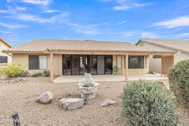 back of property featuring a patio, a tile roof, a pergola, and stucco siding