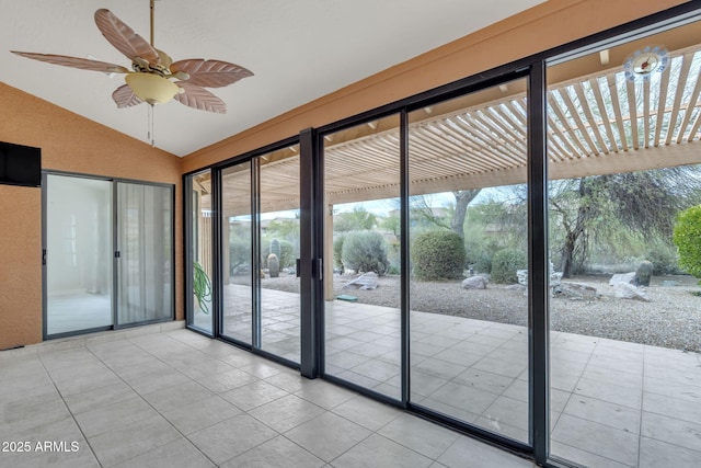 interior space featuring a ceiling fan and vaulted ceiling