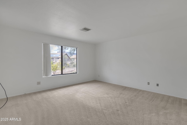 carpeted empty room with visible vents