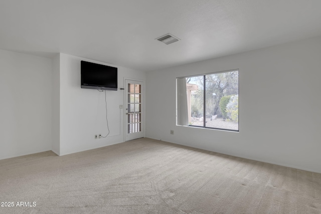 carpeted spare room with visible vents