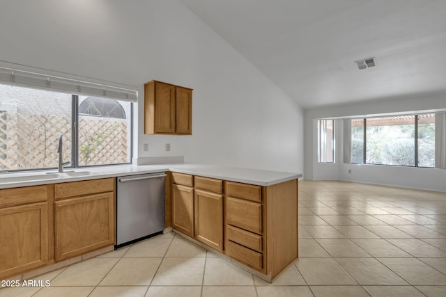 kitchen with light tile patterned floors, visible vents, a peninsula, a sink, and dishwasher