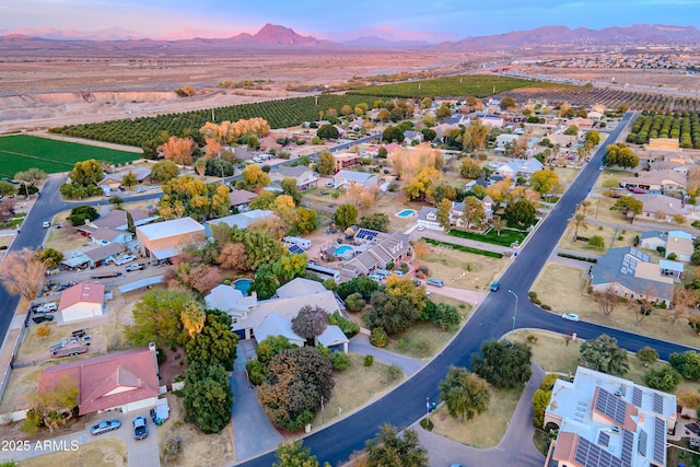 aerial view at dusk featuring a mountain view