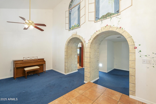 interior space with tile patterned floors and vaulted ceiling