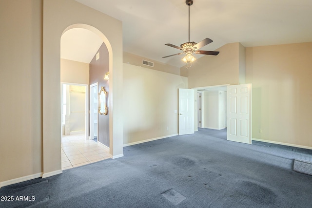 spare room with ceiling fan, light carpet, and lofted ceiling