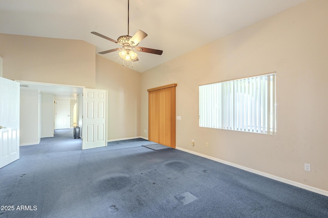 carpeted empty room with high vaulted ceiling and ceiling fan