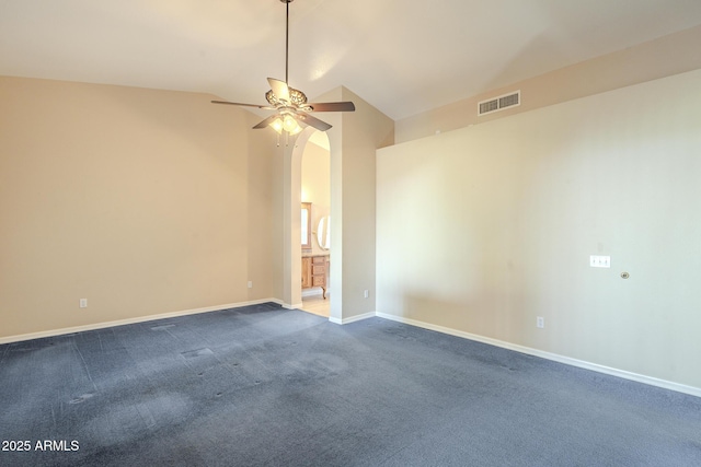 carpeted empty room featuring vaulted ceiling and ceiling fan