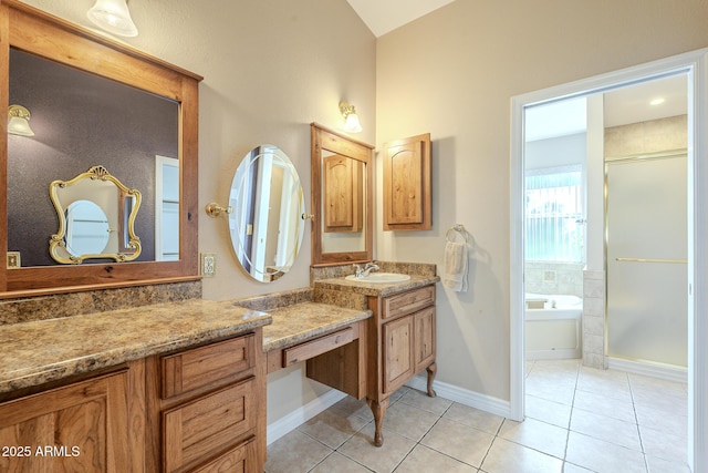 bathroom with tile patterned flooring, vanity, and shower with separate bathtub