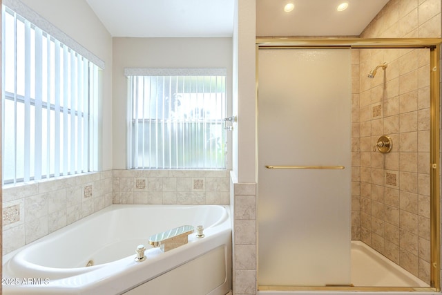 bathroom featuring shower with separate bathtub