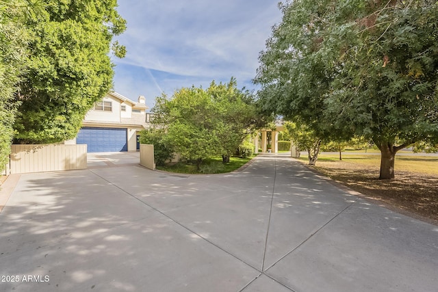 view of property hidden behind natural elements featuring a garage