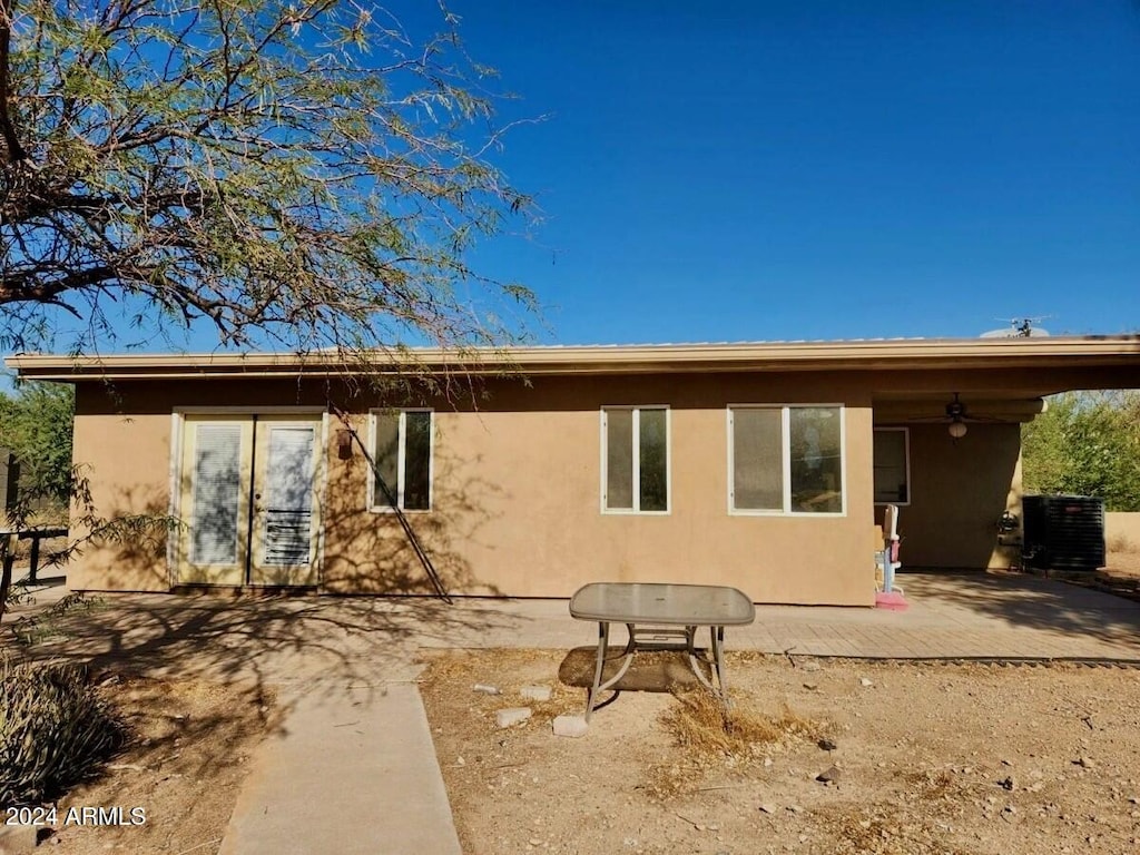 rear view of house featuring a patio area and central AC