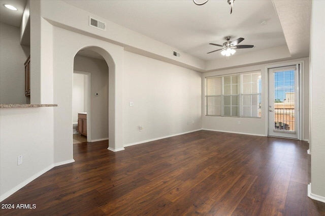 unfurnished room featuring ceiling fan and dark hardwood / wood-style flooring