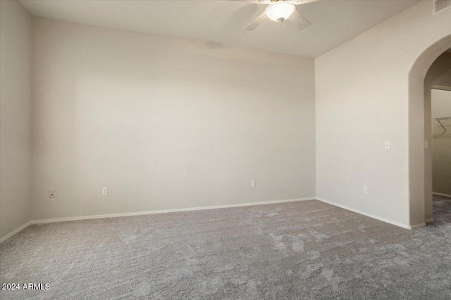 empty room with ceiling fan and carpet flooring