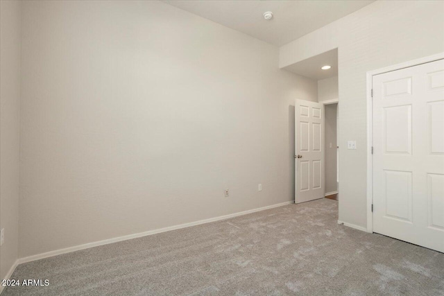 unfurnished bedroom with light colored carpet