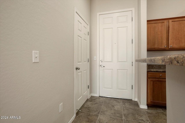 hallway with dark tile patterned floors