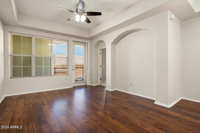 empty room featuring ceiling fan and dark hardwood / wood-style floors