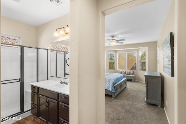 bathroom with ceiling fan, vanity, and a shower with shower door