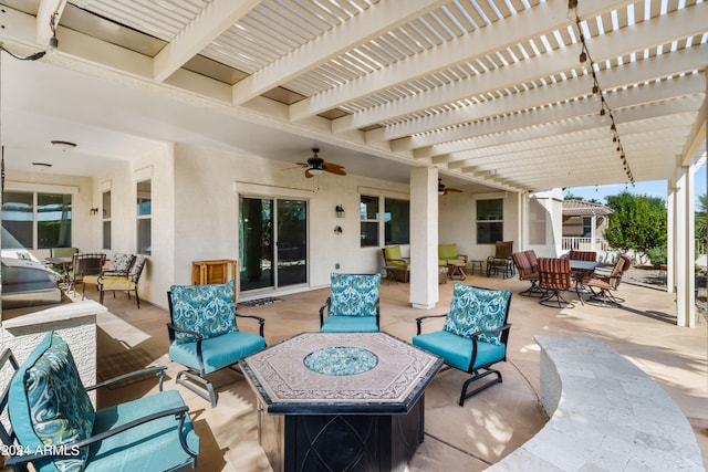 view of patio / terrace with a pergola, ceiling fan, and an outdoor living space with a fire pit