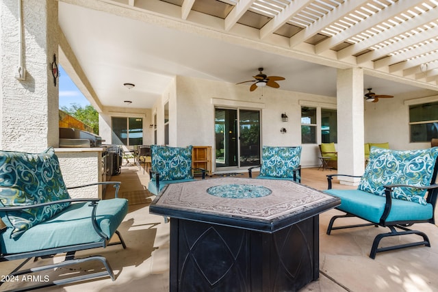 view of patio featuring a pergola, ceiling fan, and an outdoor fire pit