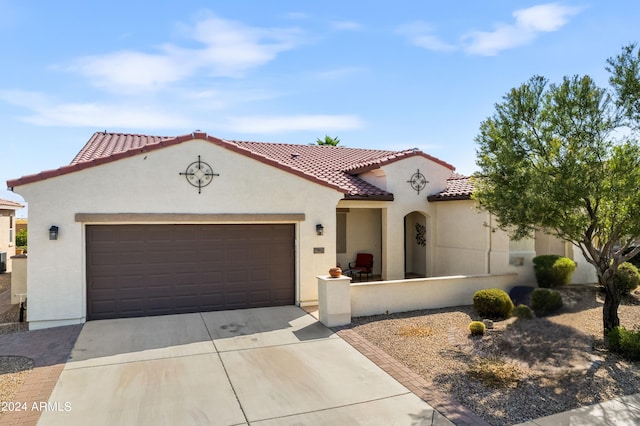 mediterranean / spanish home featuring a garage