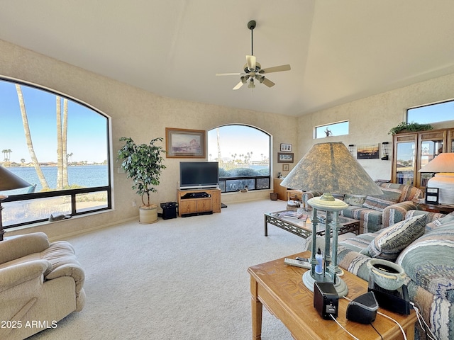 carpeted living room with ceiling fan