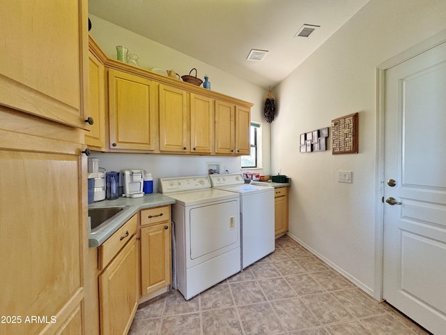 laundry room featuring visible vents, independent washer and dryer, a sink, and cabinet space