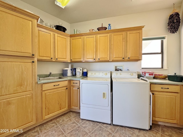 clothes washing area with cabinet space, light tile patterned floors, a sink, and independent washer and dryer