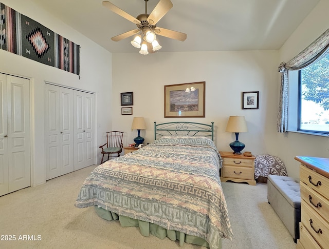 bedroom featuring ceiling fan, carpet floors, and two closets