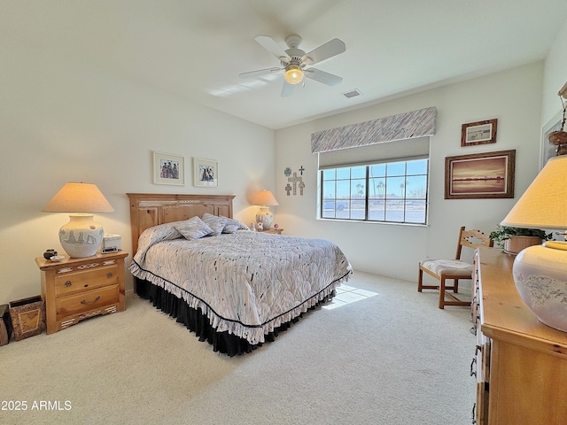 bedroom with carpet floors, visible vents, and a ceiling fan