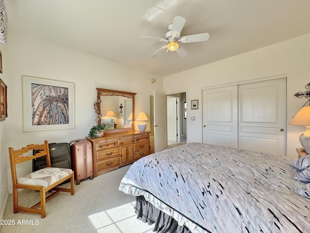 carpeted bedroom featuring a ceiling fan and a closet