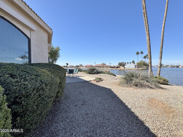 view of yard featuring a patio and a water view