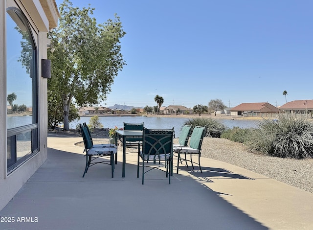 view of patio / terrace with outdoor dining area and a water view