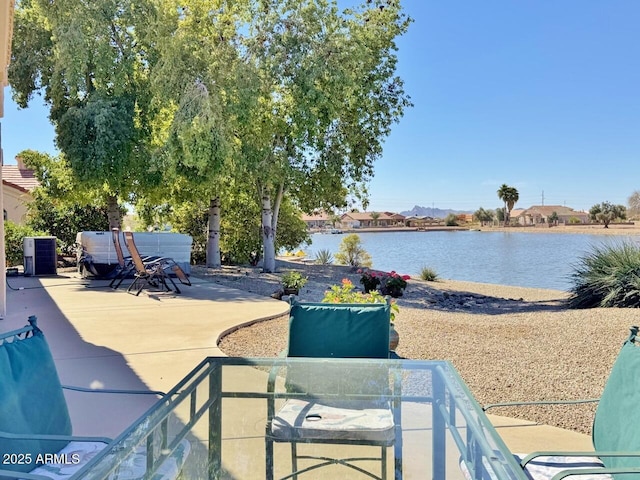 view of patio / terrace with a water view and central AC