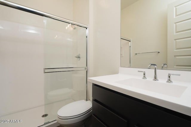 bathroom featuring vanity, toilet, and walk in shower