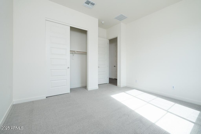 unfurnished bedroom featuring carpet floors and a closet