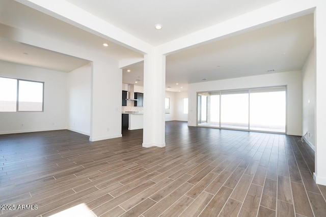 unfurnished living room with hardwood / wood-style flooring and a wealth of natural light