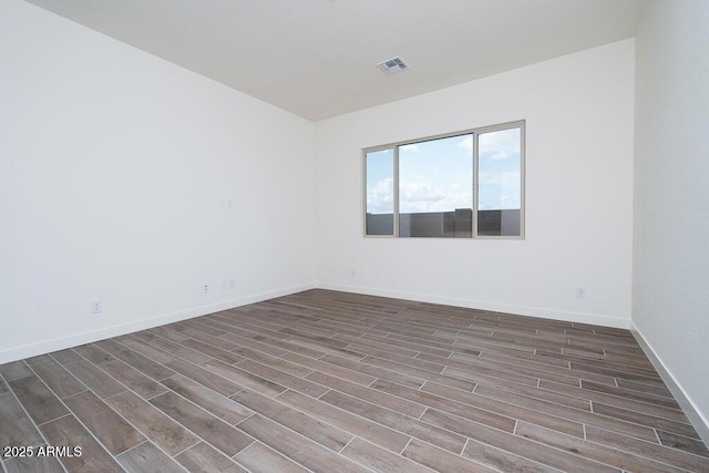 spare room featuring dark wood-type flooring