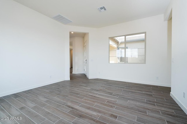 unfurnished room with dark hardwood / wood-style flooring